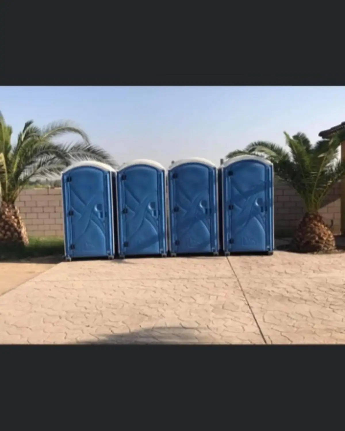 Row of portable toilets at an outdoor event